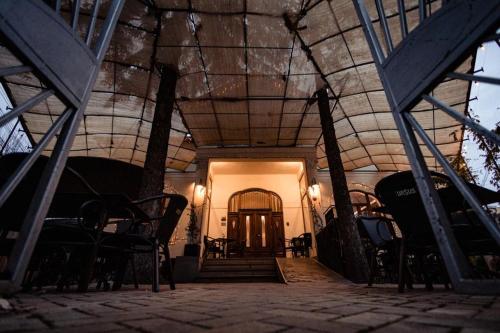 a hallway with chairs and a door in a building at Casa Del Sole in Alba Iulia