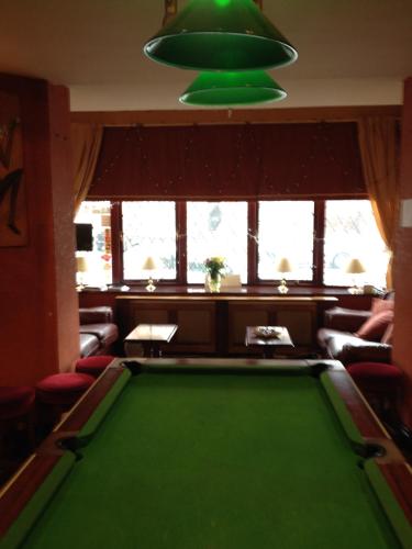 a pool table in a living room with a green at Lyndhurst Hotel in Blackpool