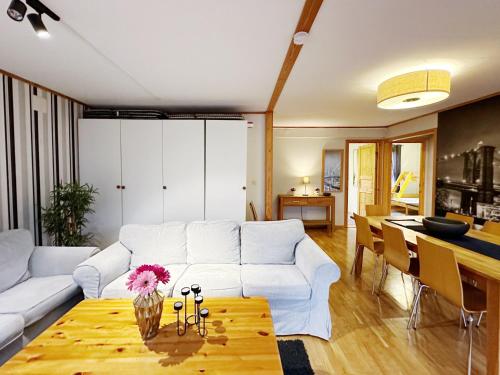 a living room with a white couch and a table at Ystad Holiday Houses in Ystad