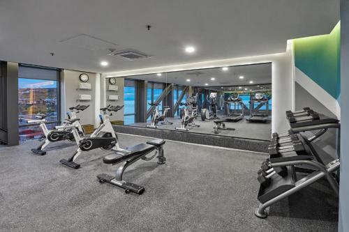 a gym with several treadmills and elliptical machines at City Express Plus by Marriott Ensenada in Ensenada