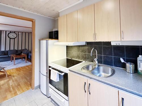 a kitchen with a sink and a stove at Ystad Holiday Houses in Ystad