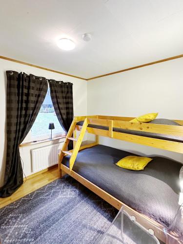 a bedroom with a bunk bed and a window at Ystad Holiday Houses in Ystad