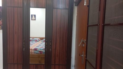 a pair of wooden doors in a room at Niks home stay -C in Trichūr