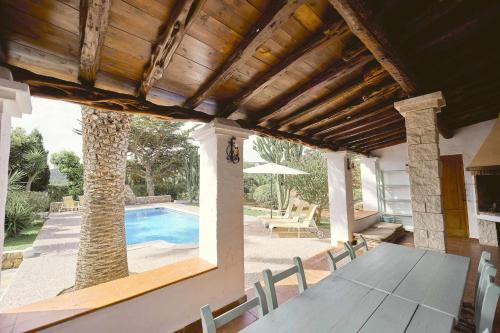 a patio with a table and a swimming pool at Can Valencià in Montecristo