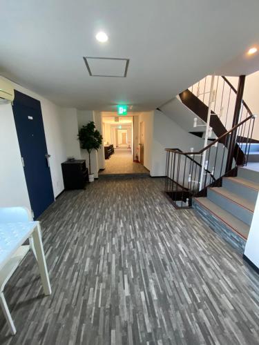 an empty hallway with stairs in an office building at MR TOMO FUJI in Fuji