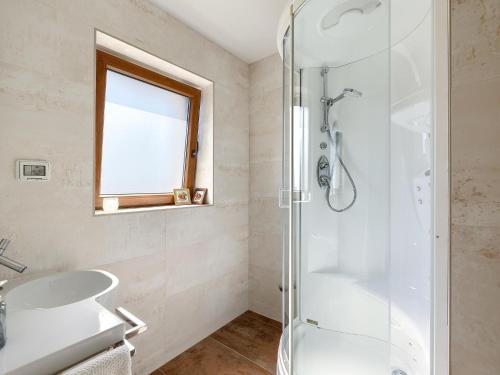 a bathroom with a shower and a sink at Lovely villa with swimming pool and terrace in Hreljići