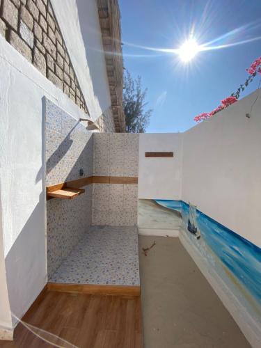 a bathroom with a sink and a swimming pool at Laguna Blu - Resort Madagascar in Andavadoaka