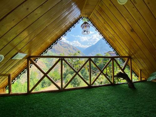 a window in a room with a view of a mountain at Himalayan Abode Tree House in Sainj