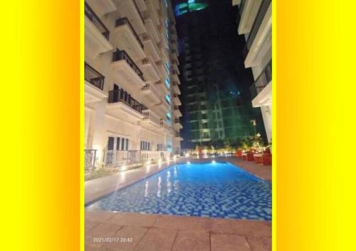 a large swimming pool in the middle of a building at Unit 3J Signature Suites, Lafayette Megaworld in Iloilo City