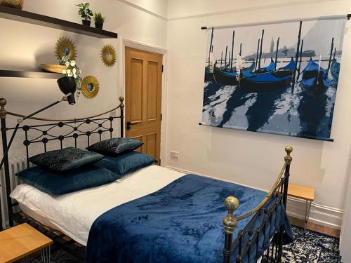 a bedroom with a bed and a painting of boats at Colchester house in London