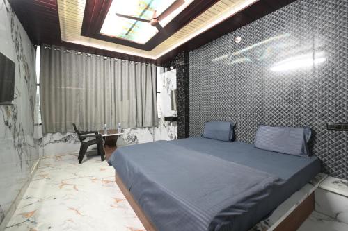 a bedroom with a large bed in a room at SRS GRAND in Hyderabad