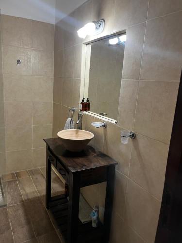 a bathroom with a sink and a mirror at Casa Rava in Santiago del Estero