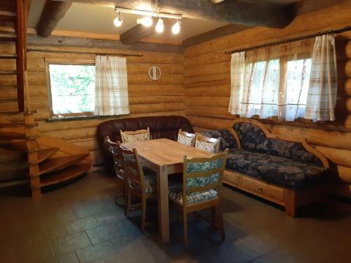 a dining room with a table and a couch at Ceļinieks in Babīte