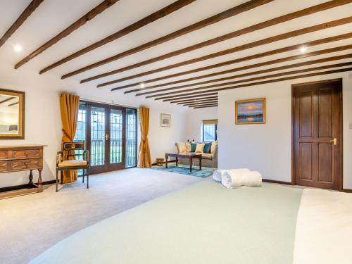 a bedroom with a large bed and wooden ceilings at Prince Of Wales Lodge in Caston