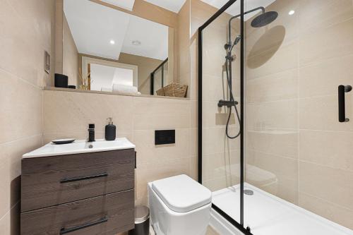 a bathroom with a shower and a toilet and a sink at Chatsworth Suite - Apartment 27 in Tideswell