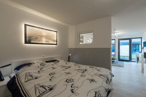 a bedroom with a bed with a comforter on it at Ankerplatz in Büsum
