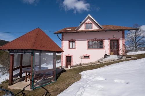 a house with a gazebo in front of it at Domaćinstvo Spasenić in Ribnica