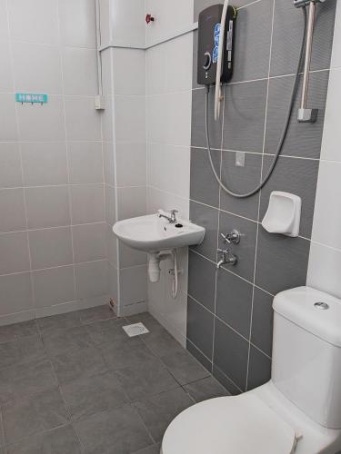a bathroom with a toilet and a sink at UG Homestay BP - Netflix & 4 Air-Con Rooms in Batu Pahat