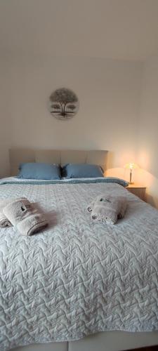 a white bed with two pillows on top of it at Vila Irina Kopaonik in Kopaonik