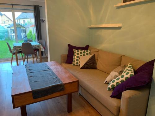 a living room with a couch and a table at 2 bed Cozy Home Lusk - 15min from Dublin airport! in Lusk