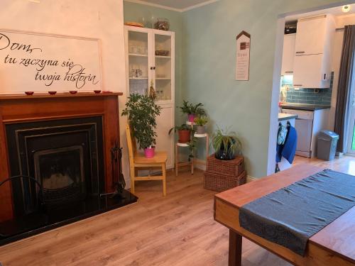 a living room with a fireplace and a table at 2 bed Cozy Home Lusk - 15min from Dublin airport! in Lusk