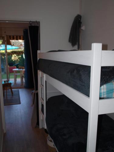 a white bunk bed in a room with a table at Studio le Mistral in Saint-Raphaël