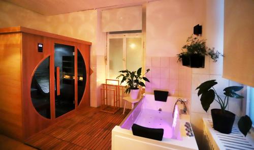 a bathroom with a bath tub and a sink at Magnetfels in Lenzkirch
