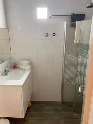 a bathroom with a shower and a sink at Sweet li junior in Ashqelon