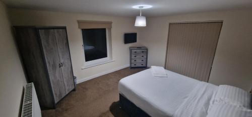 a bedroom with a white bed and a window at APARTMENT IN CENTRAL HALIFAX in Halifax