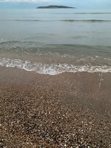 a beach with the ocean and the shoreline at 2 bed Cozy Home Lusk - 15min from Dublin airport! in Lusk