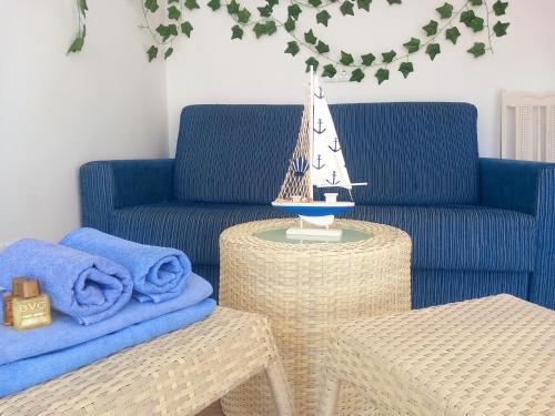 a living room with a blue couch and a table at Castell d'Almansa in Cambrils