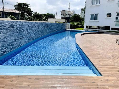 a swimming pool with blue water in a building at Apartment in the heart of Accra. in Accra