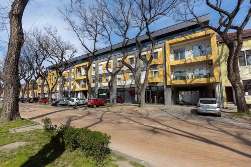 a building with cars parked in front of it at DONNER LUXURY APARTMAN in Subotica