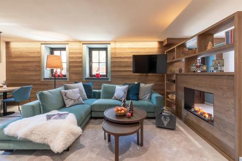 a living room with a couch and a fireplace at Cima Dodici B&B - Apartments in Sesto