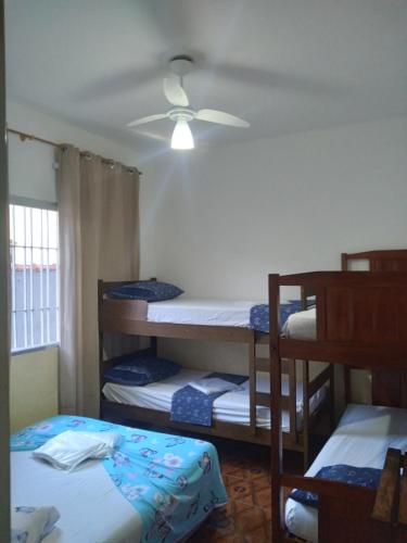 a room with four bunk beds and a ceiling at pousada&Hostel perola mar in Mongaguá