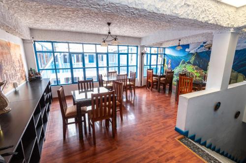 a dining room with tables and chairs and a bedroom at La Casona de Rimacpampa in Cusco