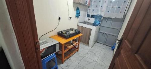 a small kitchen with a stove on a table at Humble homes 1 bedroom Thika Cbd in Thika