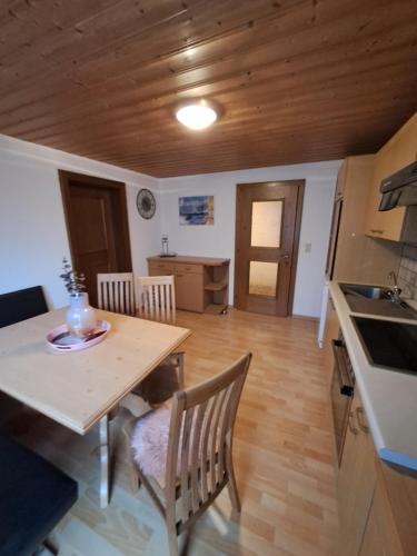 a kitchen and dining room with a table and chairs at Ferienwohnung Nancy in Jerzens