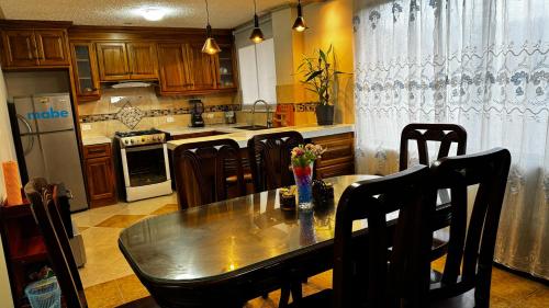 uma cozinha com mesa e cadeiras e uma cozinha com fogão em Wasi Golde oro em Otavalo