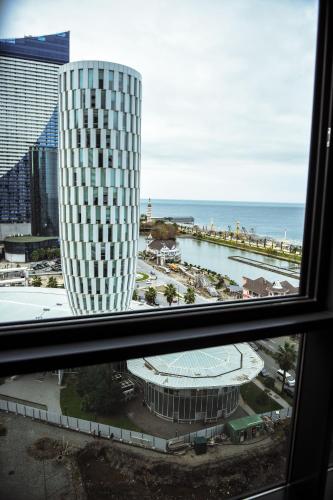 a view from a window of a building and the ocean at Premium apartments - the star of Batumi Palace in Batumi