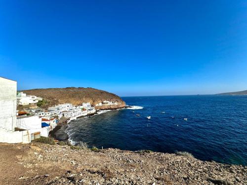 a group of buildings on the shore of the ocean at Black Sand Loft in Telde