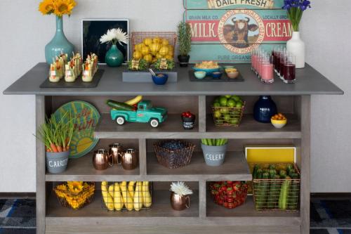 a shelf with fruits and vegetables and a toy truck at Le Méridien Chicago - Oakbrook Center in Oak Brook