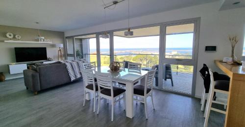 comedor y sala de estar con mesa y sillas en Piso Premium Vistas Mar & Golf en Mar del Plata