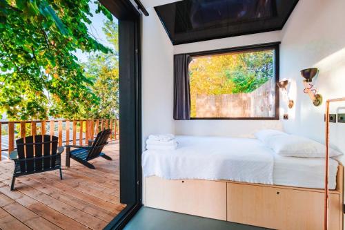a bedroom with a bed and a window on a deck at Kartepe LOFT in Kocaeli
