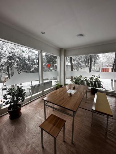 a large room with a wooden table and benches at Guest house Family7 in Osh