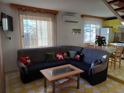 a living room with a blue couch and a table at HutiFeri apartman in Siófok