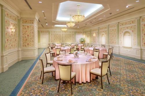 a banquet room with tables and chairs and a chandelier at Nagoya Marriott Associa Hotel in Nagoya