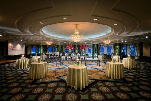 a ballroom with tables and chandeliers in a room at Nagoya Marriott Associa Hotel in Nagoya