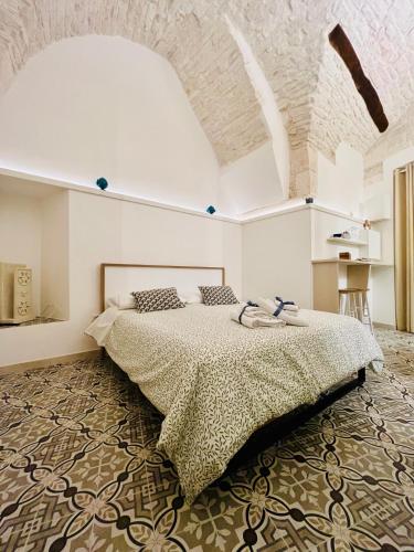 a bedroom with a large bed in a room at Le Marangi Getaway Suite in Martina Franca