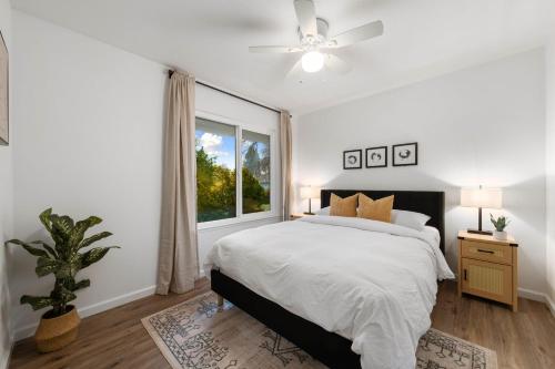 a white bedroom with a bed and a window at Sacramento Gem w Cozy Wood Fireplace BBQ Grill in Sacramento